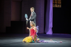 Duchess kneeling to audience with escort by her side