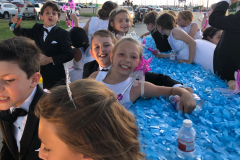 Children of the court on a float smiling at the camera